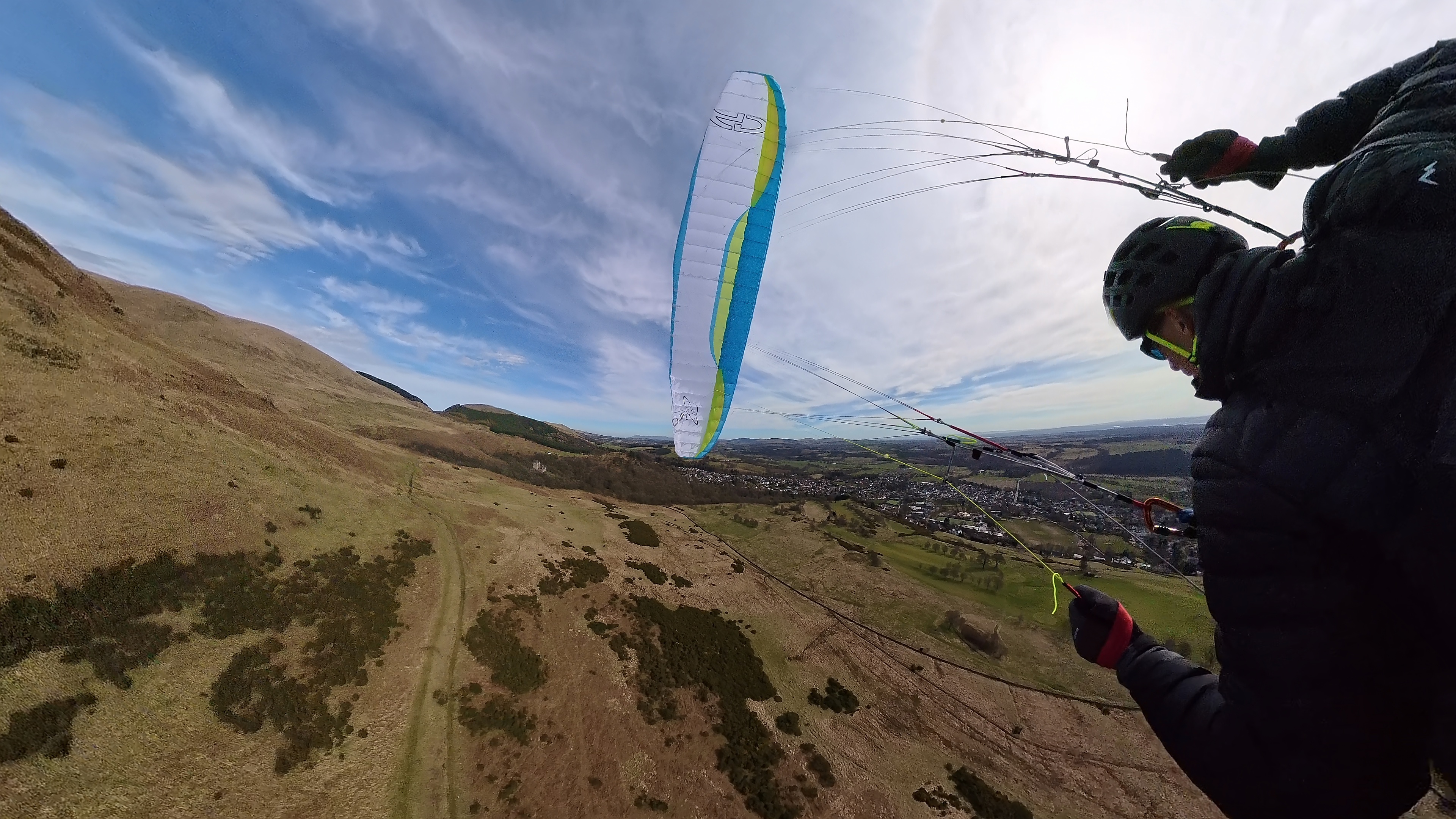 Paraglider view over hills.